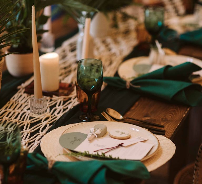 Botanical tablescape with green napkins and macrame table runner