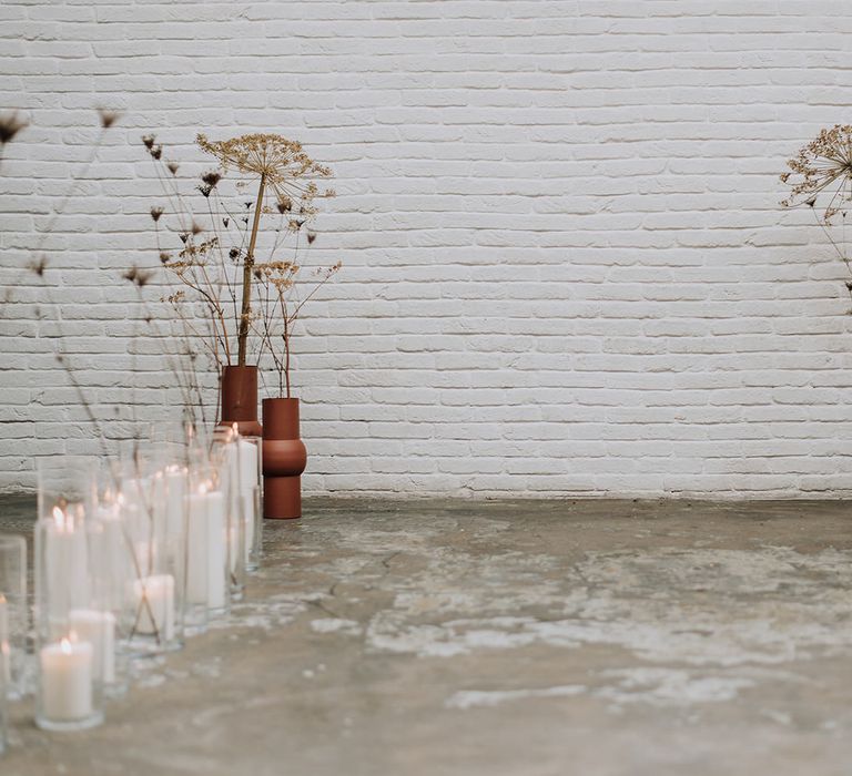 Minimalist industrial candle wedding aisle with fried flowers for all white wedding