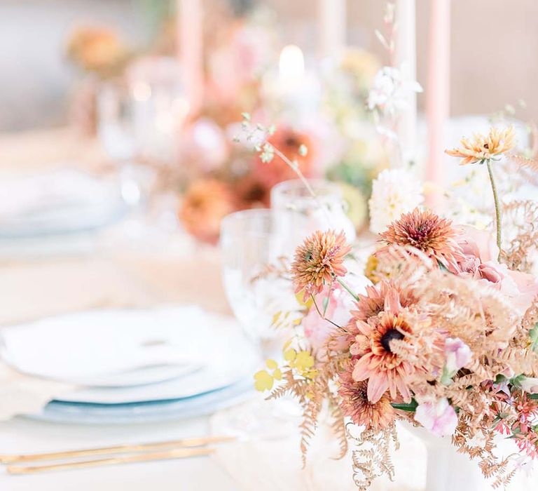 Blush pink wedding table flowers and taper candle reception decor