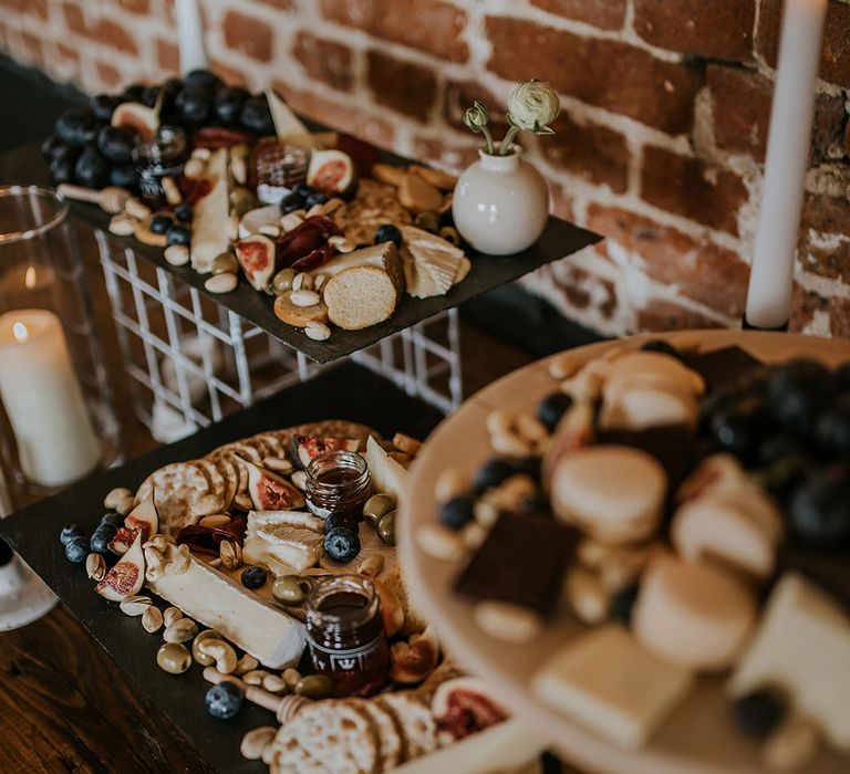 Antipasti grazing table with cheese, crackers, olives, pickles and grapes 