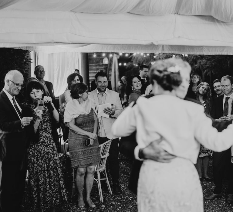 Bride & groom have their first dance as wedding party watch