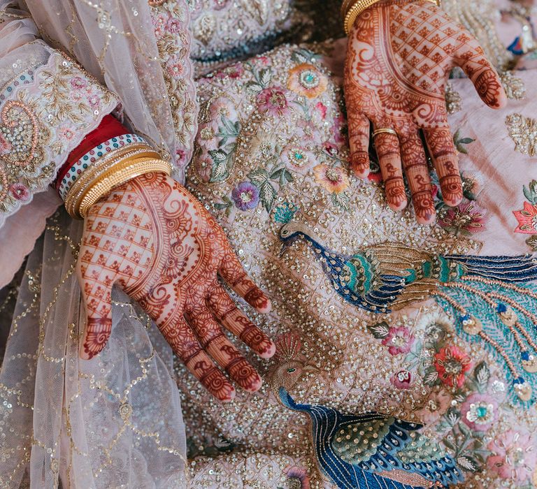 Bride shows her henna covered hands for wedding day