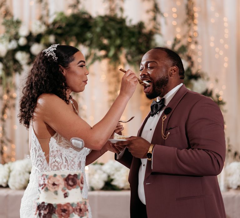 Bride & groom laugh with one another during their wedding reception