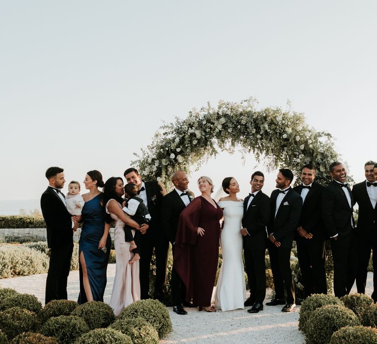 Bride & groom stand with their wedding party after wedding ceremony in Greece | Hannah MacGregor Photo & Film