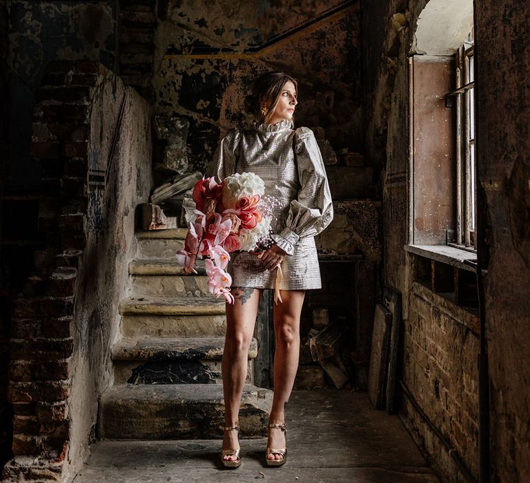 Cuff sleeve shiny short gold dress and a vibrant pink blush bouquet 