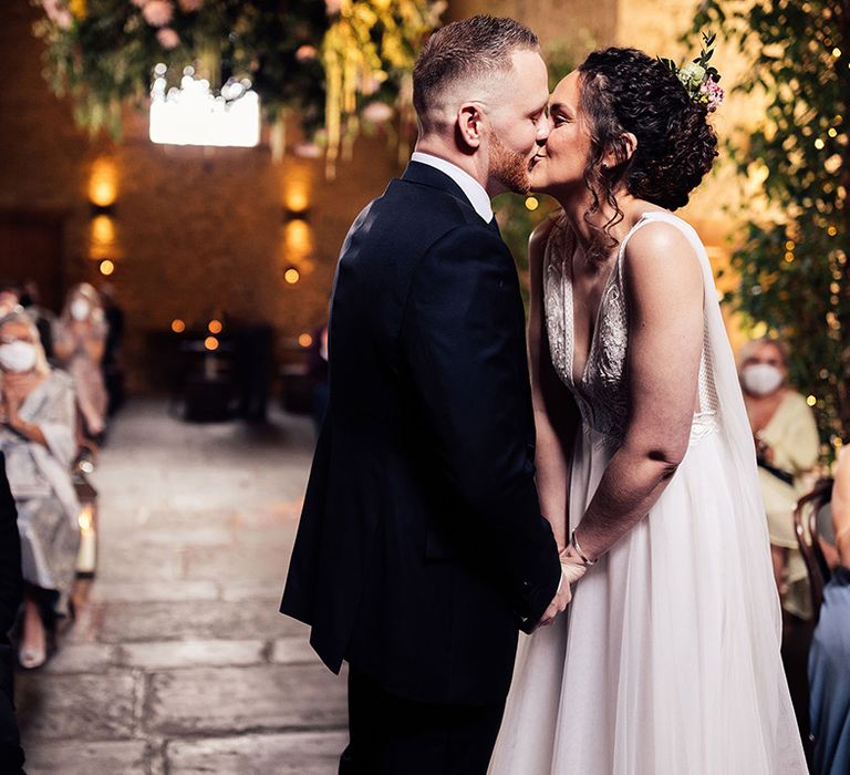 Bride and groom kiss at intimate ceremony at Cripps Barn with Riley dress Made With Love Bridal