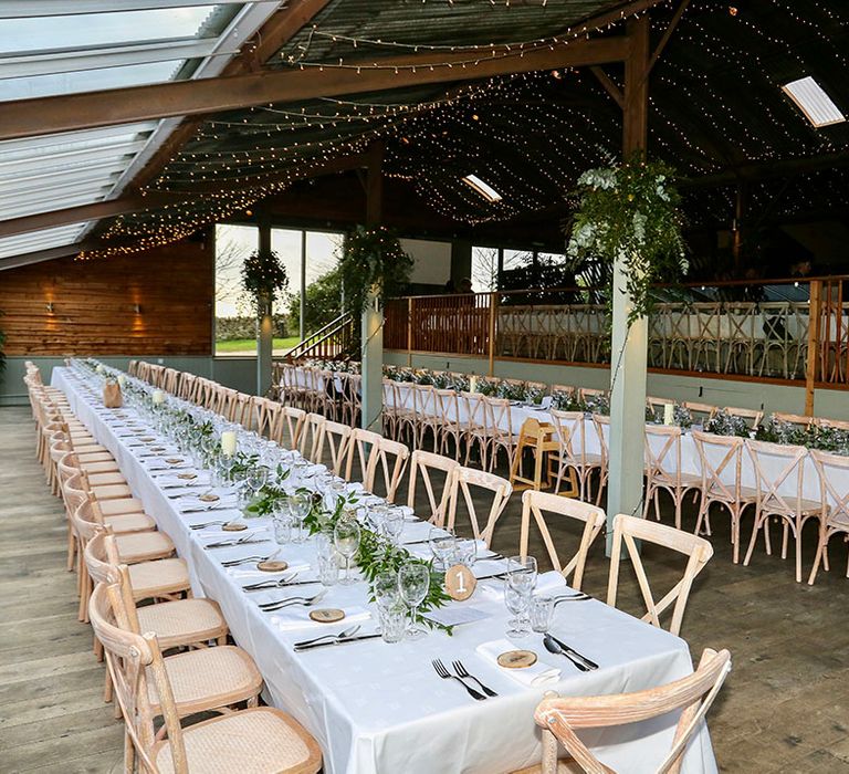 Rustic style tables complete with white table cloth 