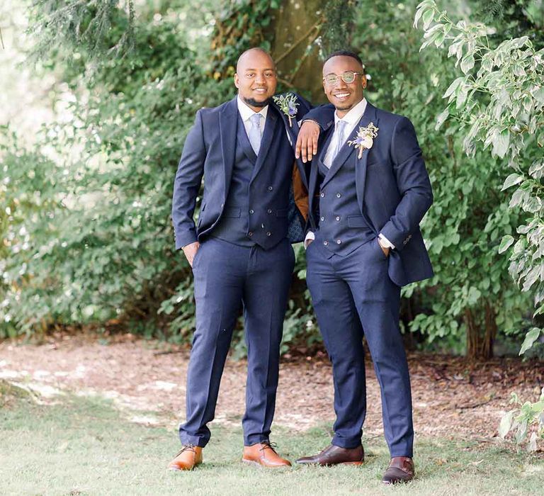 Groom stands with his groomsmen on his wedding day