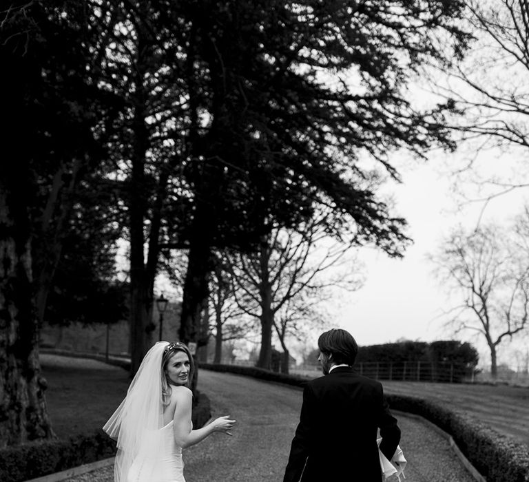 Bride & groom walk with one another on their wedding day 