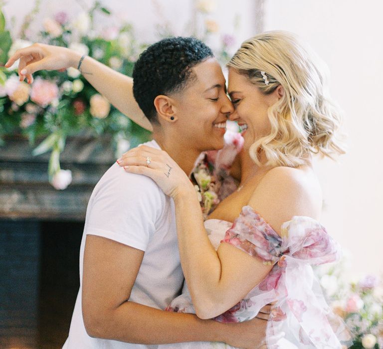 LGBTQI+ couple kissing at Barnett Hill Hotel with bride in a strapless pink wedding dress 