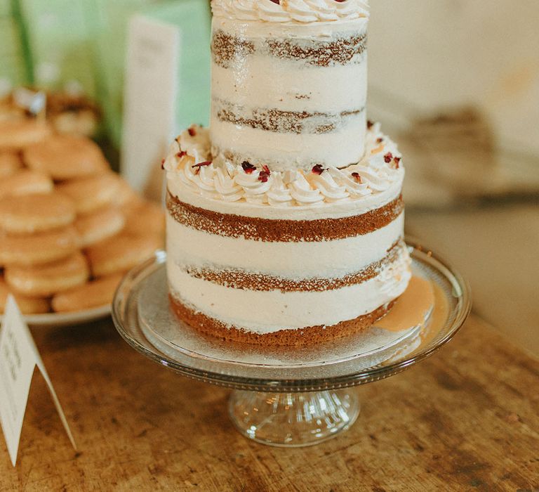 Two-tier semi-naked white frosted vanilla and salted caramel vegan cake