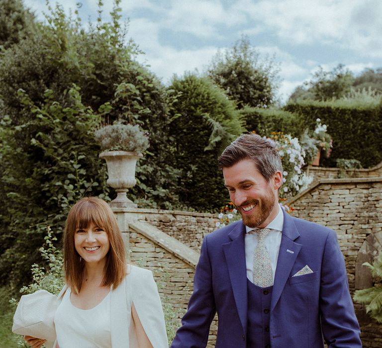 Wedding guest fashion with a bright pink skirt and fun patterned tie