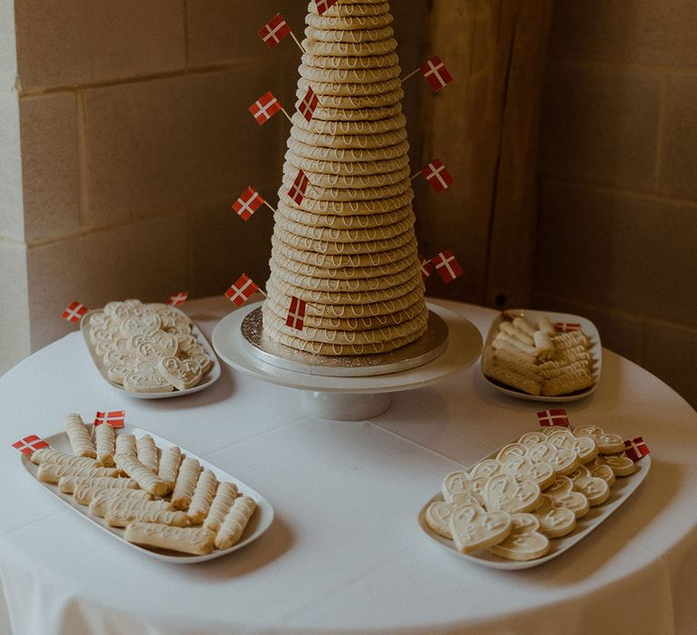 Traditional Kransekake from Denmark with personalised wooden cake topper surrounded by personalised biscuits 