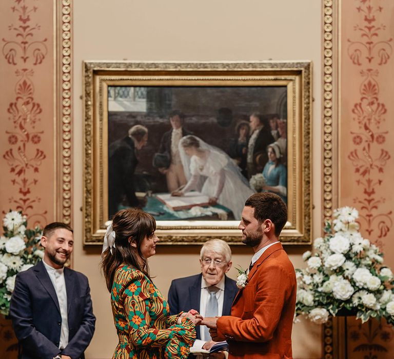 Bride & groom wear brightly coloured outfits on their wedding day during Registry Office wedding ceremony in Bristol 