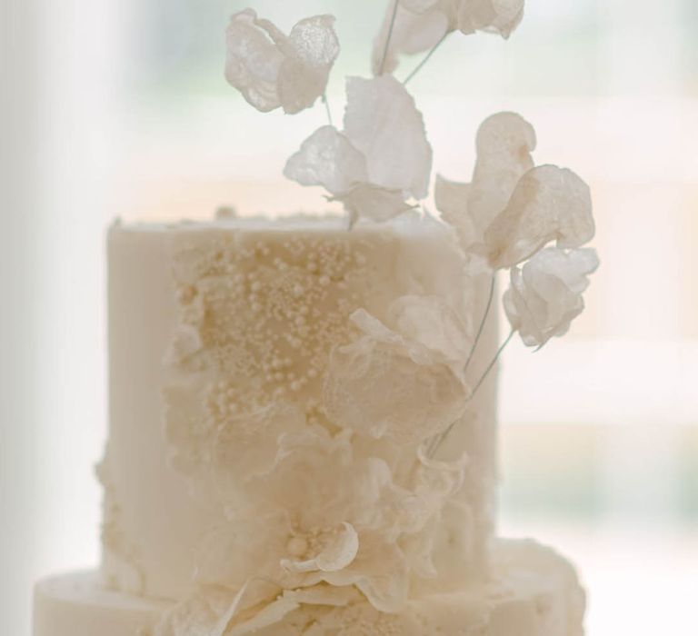 Close up on the classic white two tier wedding cake with pretty and elegant texture detail 