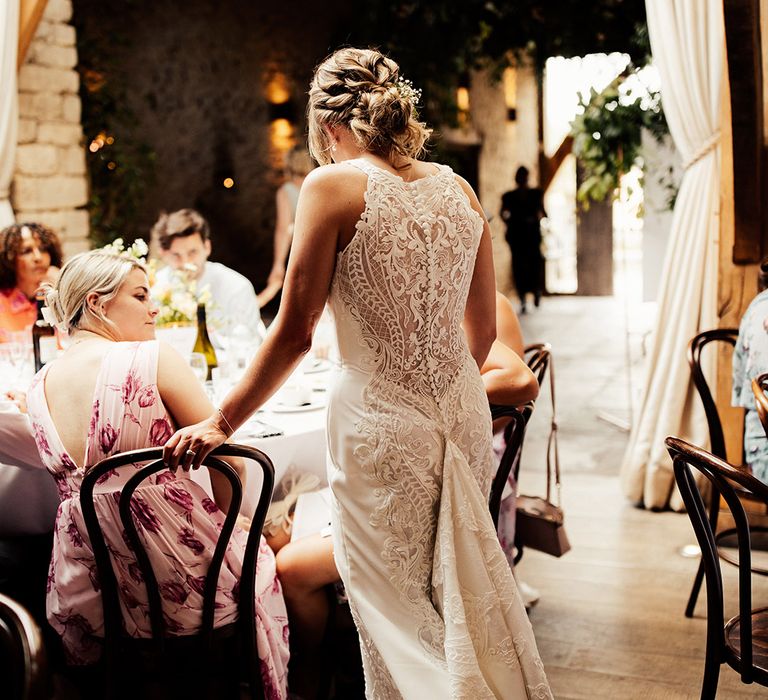 Bride in a lace back wedding dress with button details 