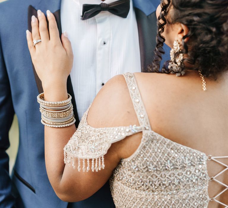 Groom wears black tie with blue jacket and black lapels