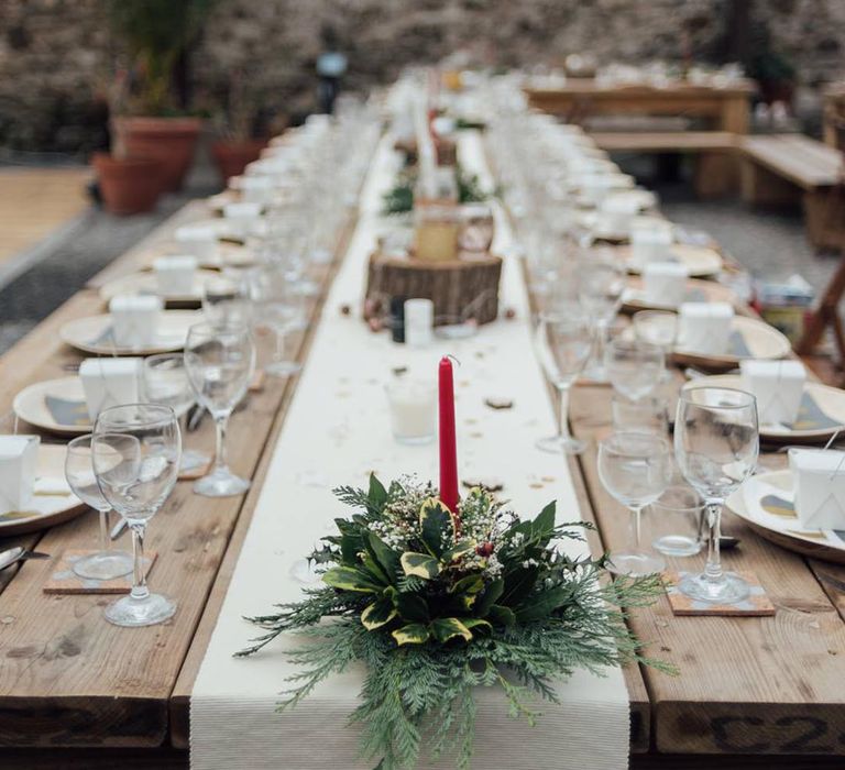 Small red candle and green foliage for simple winter wedding tablescape 