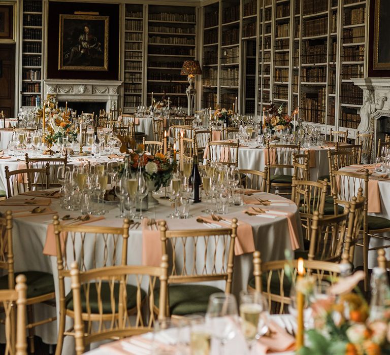 Autumnal tablescapes with orange and peach wedding flowers, matching taper candles, napkins and more 