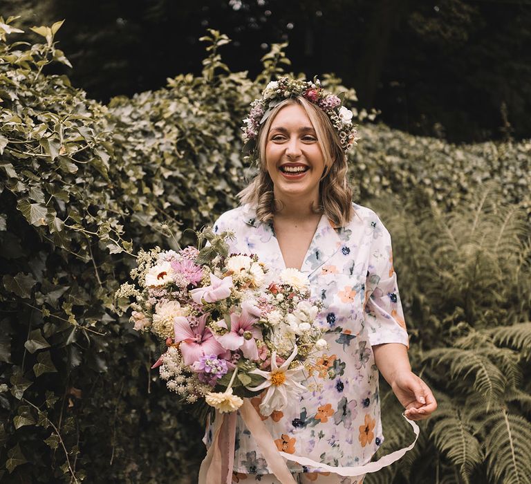 Bride in floral print pyjamas holding pink and pastel bridal bouquet for botanical boho wedding 