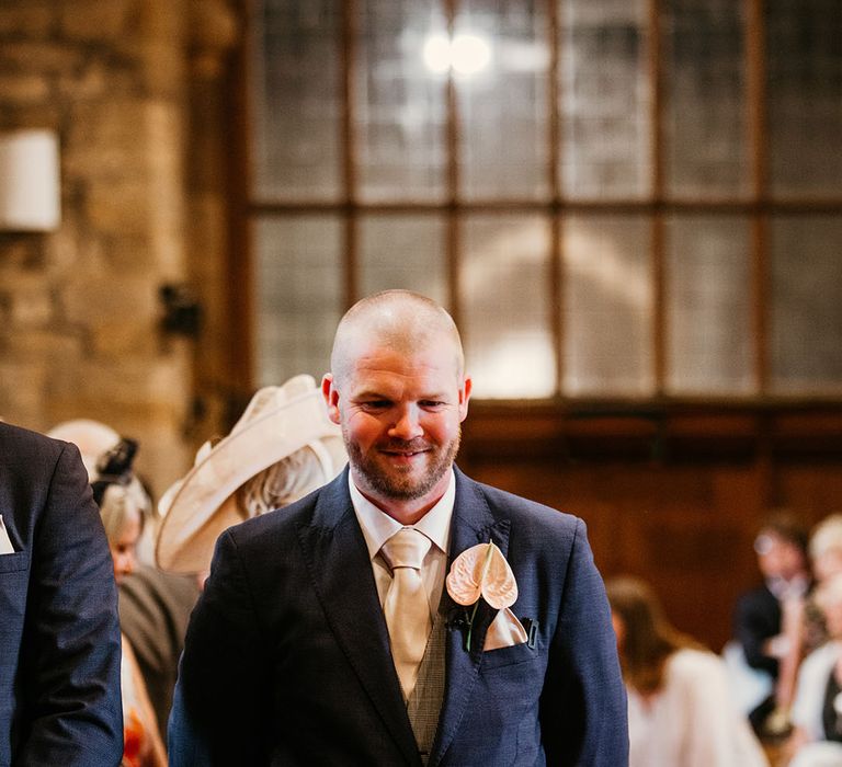 Groom in navy wedding with pink anthurium buttonhole 