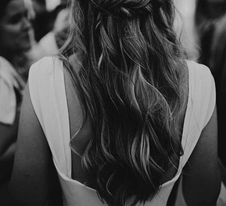 half up half down wedding hair with white enamel flower pin hair accessory 