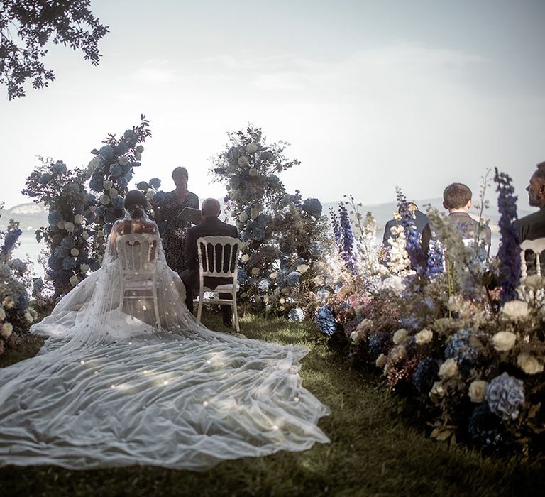 Bride wearing insane cathedral length wedding veil at Tuscany wedding 