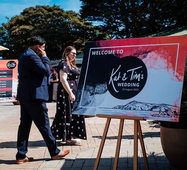 Red, black and white wedding welcome sign for coastal wedding 