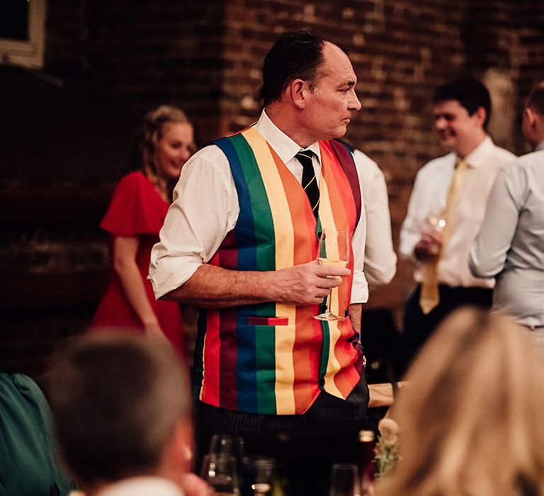 Wedding guest in bright rainbow waistcoat 