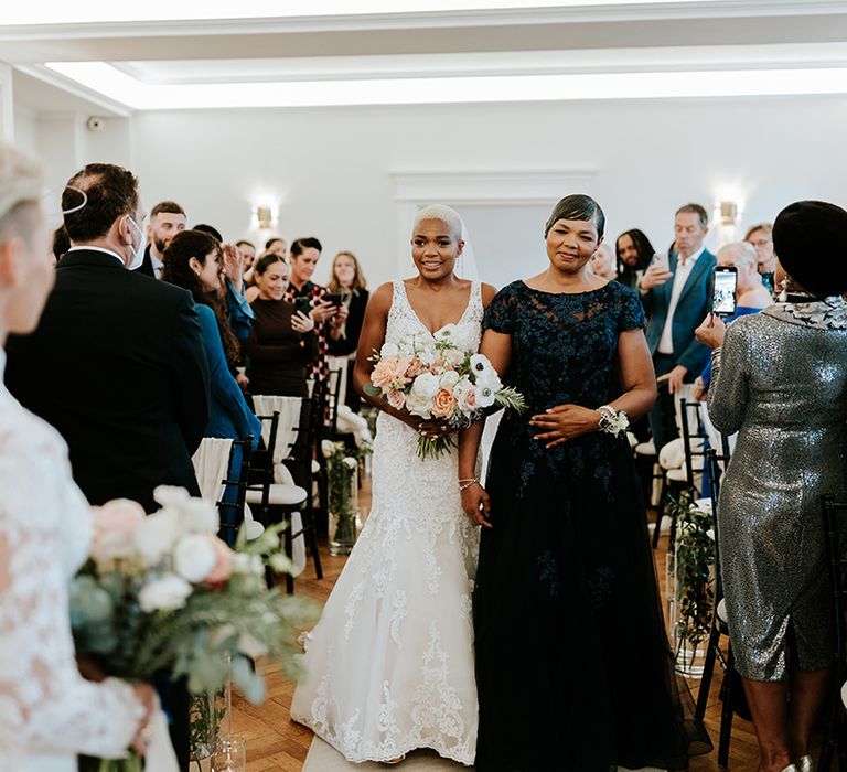 Sant Ffraed House wedding ceremony with bride being walked down the aisle by her mother 