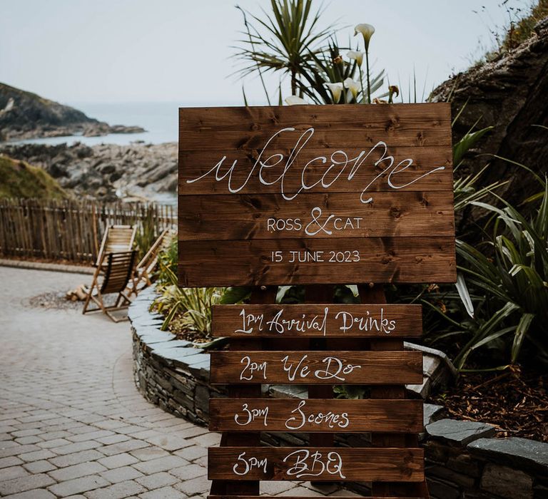 DIY rustic wooden welcome and order of the day sign 