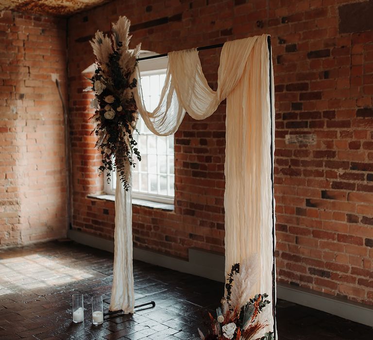 Boho wedding at The West Mill with altar decorations with dried wedding flowers including pampas grass and white roses 