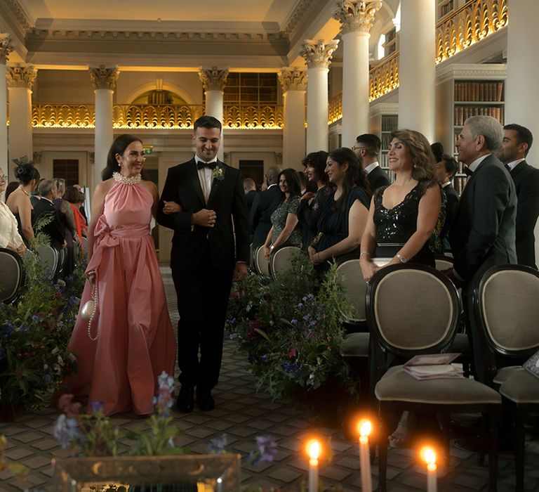 Members of the wedding party walking down the aisle 