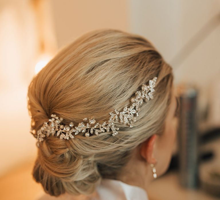 Bride with blonde hair in an updo hairstyle with sparkly hair accessory 