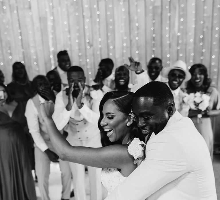 Groom dances behind the bride for their first dance 