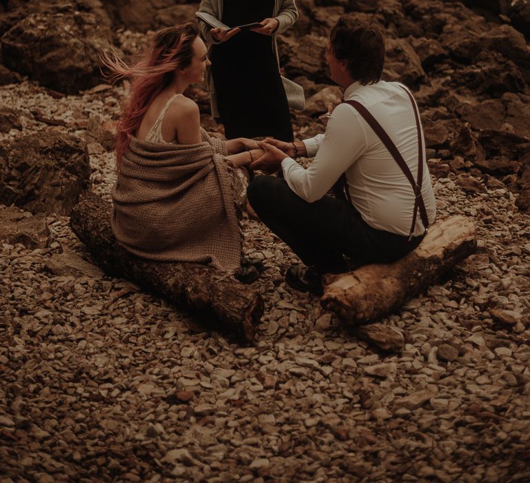 Bride and groom exchanging vows on the beach