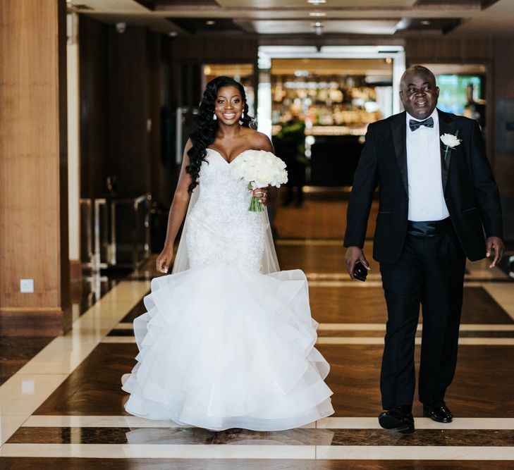 Bride in fishtail wedding gown with her father 