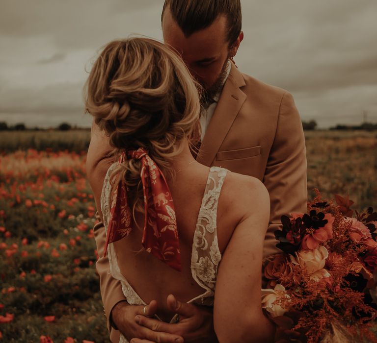 LAce low back wedding dress and wedding hair tied with a scarf