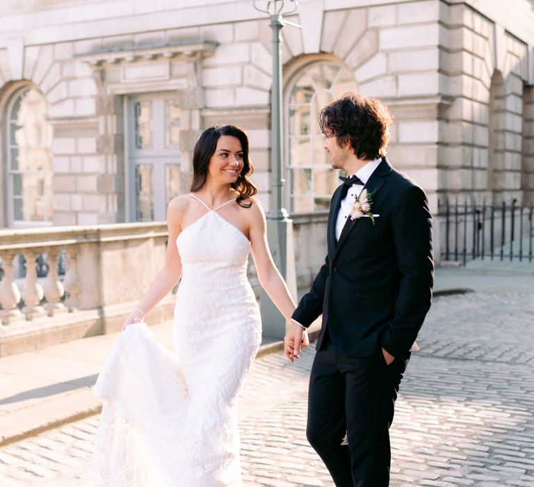 Bride and groom at London wedding with halter neck wedding dress