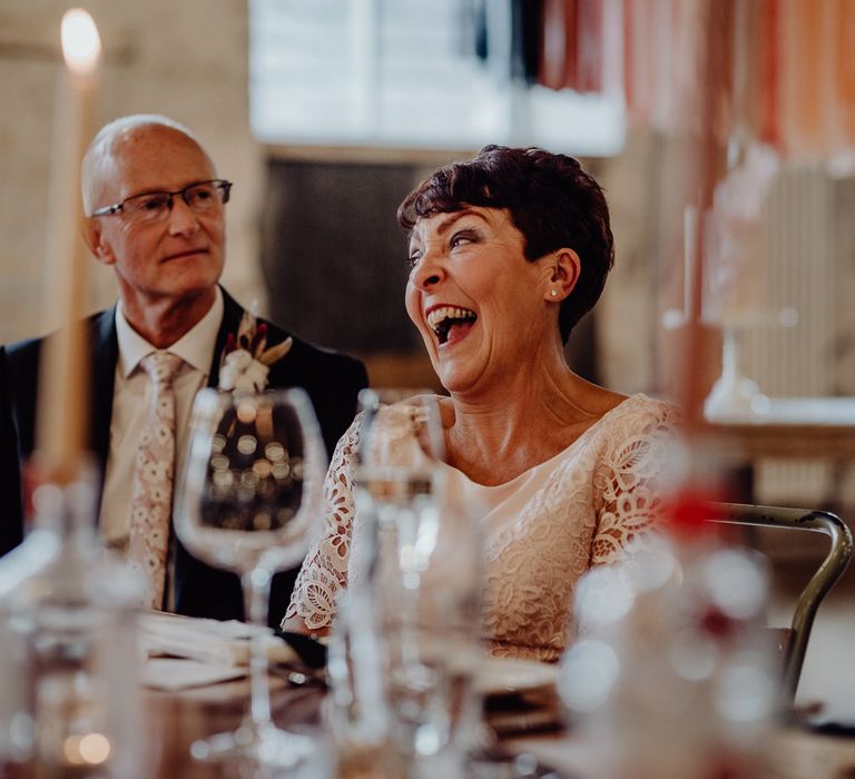 Wedding guests laughing during the speeches