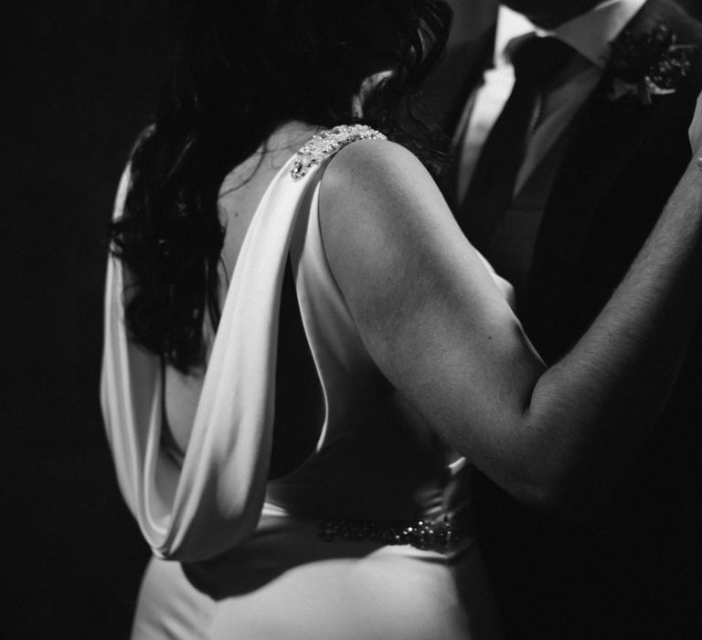 Black & white image of bride and groom dancing