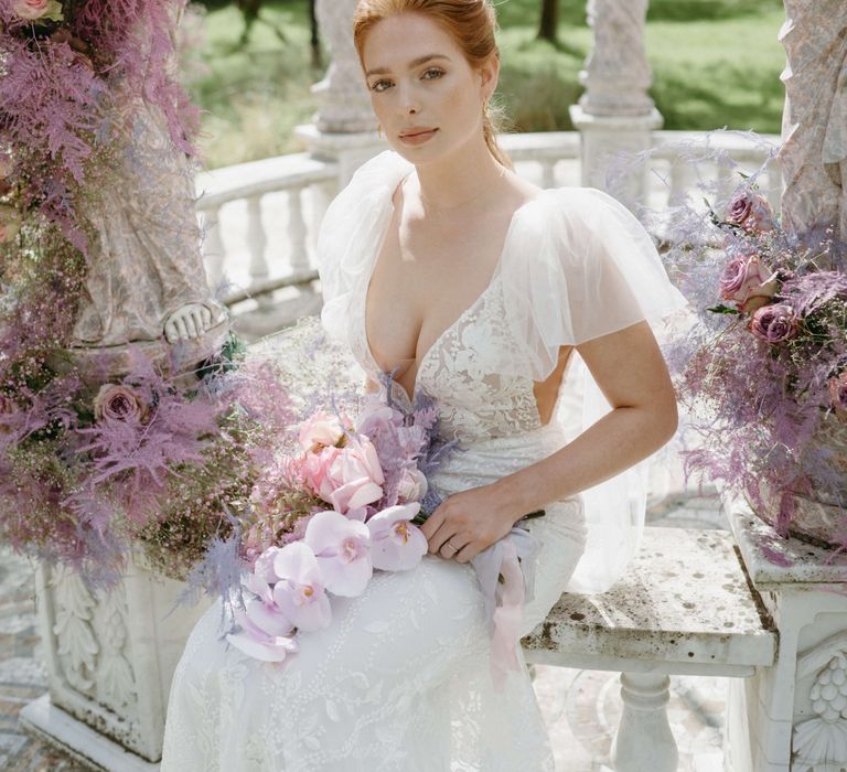 Bride looks toward the camera in ethereal gown