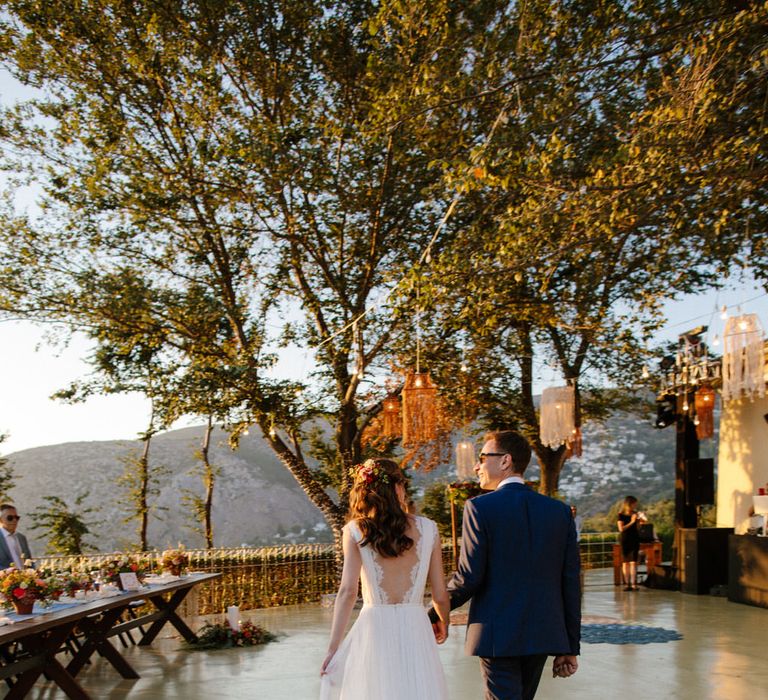 The bride and groom entering their destination wedding reception in Greece