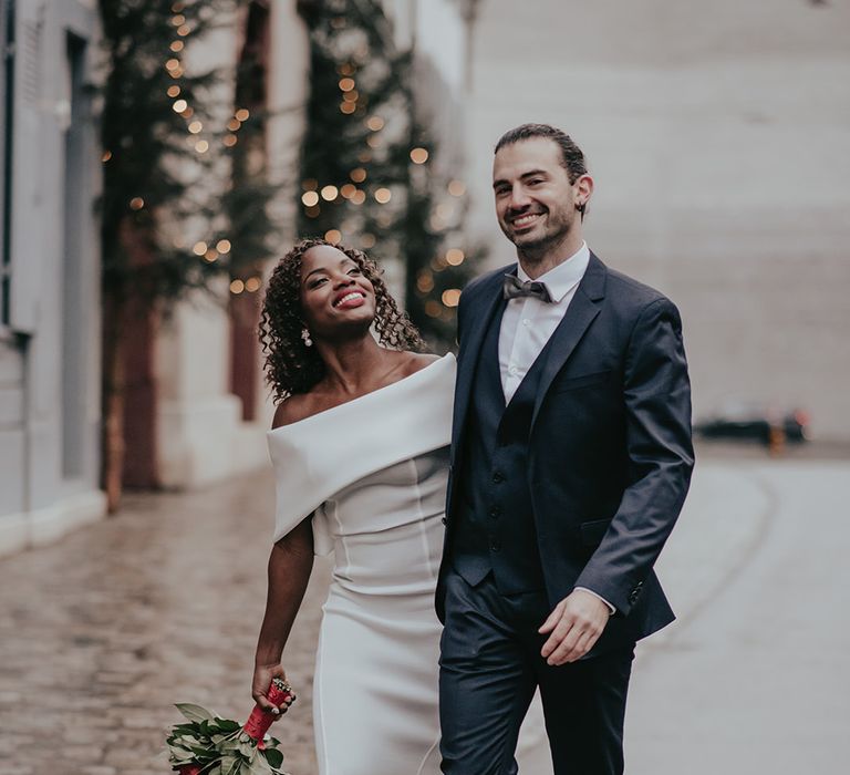 Bride & groom stand together after wedding ceremony on the streets of Switzerland 