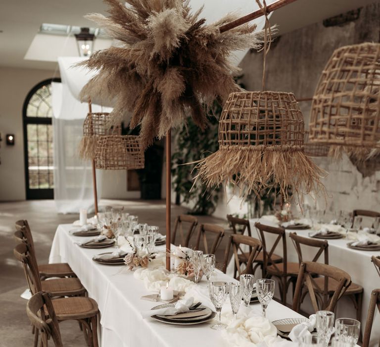 earthy wedding decor with pampas grass installation and wicker lamp shades at The Fig House in Middleton Lodge 