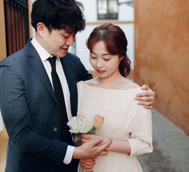 Asian couple embrace on street in Seville