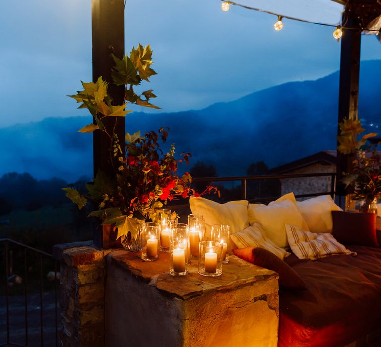 Pillar candles lighting up intimate wedding dinner in the Italian mountains