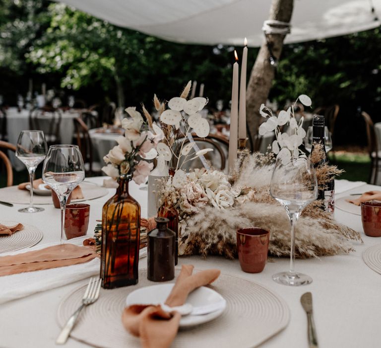 Neutral tone wedding table decor with pampas grass