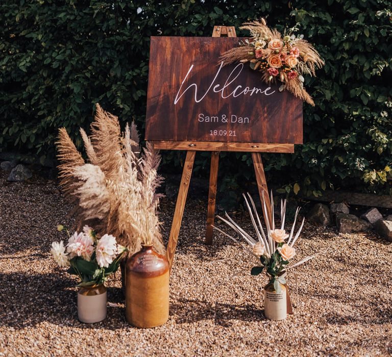 Wooden welcome signage with Pampas grass installation 