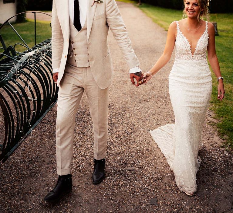 Bride and groom hold hands at Preston Court wedding